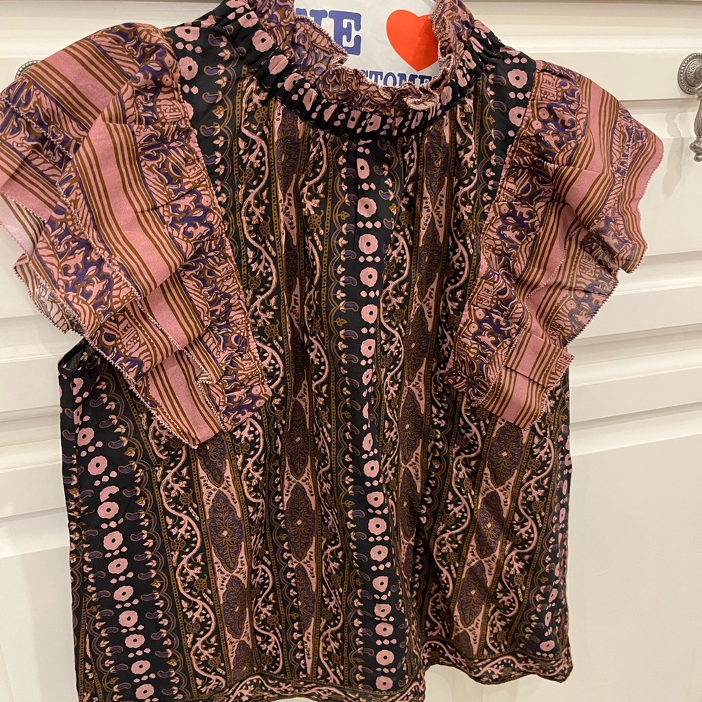 Gorgeous anthropology top! Never worn. Beautiful ruffle detail on sleeves.